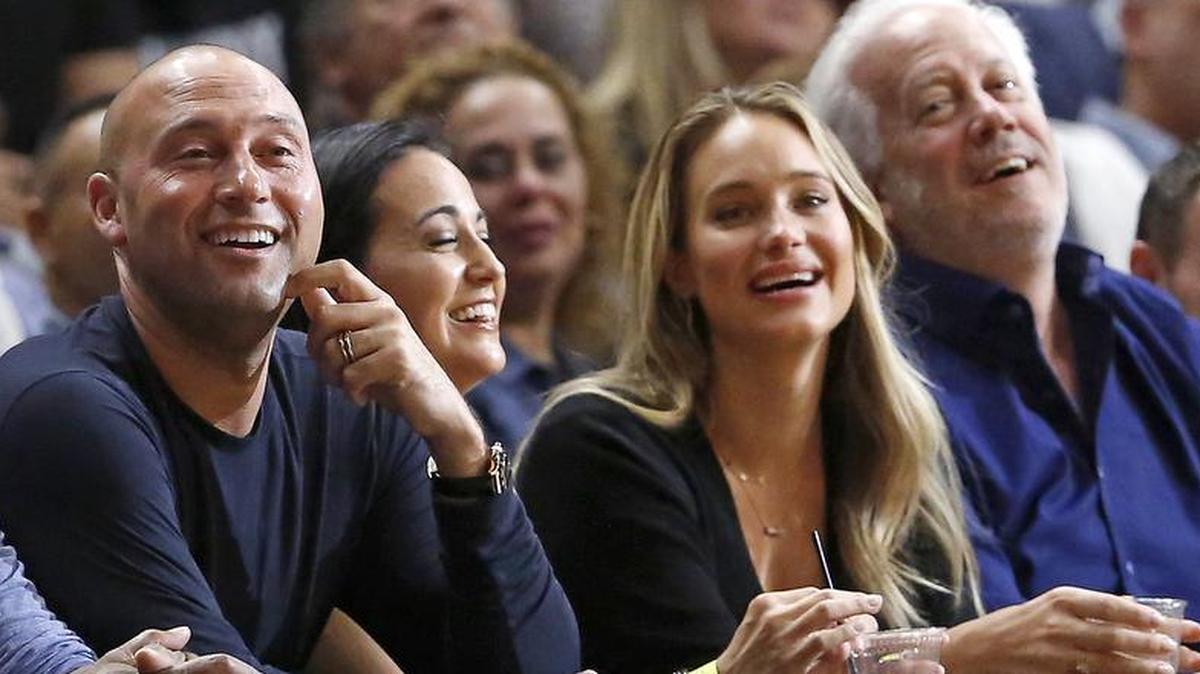 Miami Marlins chief executive and part-owner Derek Jeter and his wife, Hannah Davis, watch a Miami Heat game Dec. 3.
