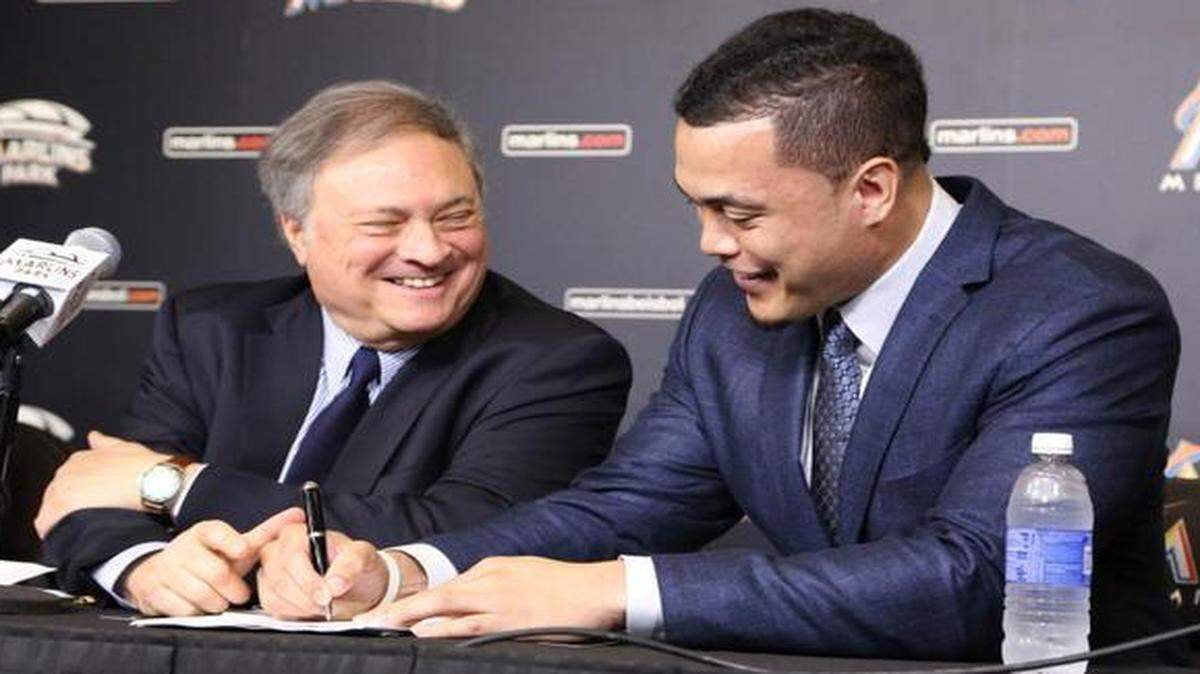 
Giancarlo Stanton signs a 13-year, $325 million contract as Marlins owner Jeffrey Loria looks on Wednesday, Nov. 19, 2014 at Marlins Park. 
