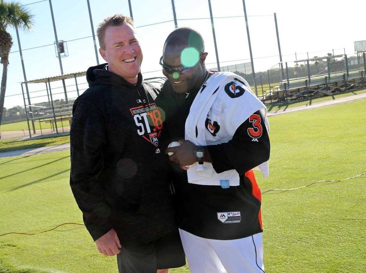 Rock Hughes, left, shares a laugh with Quinton McCracken, outfield/baserunning coordinator.