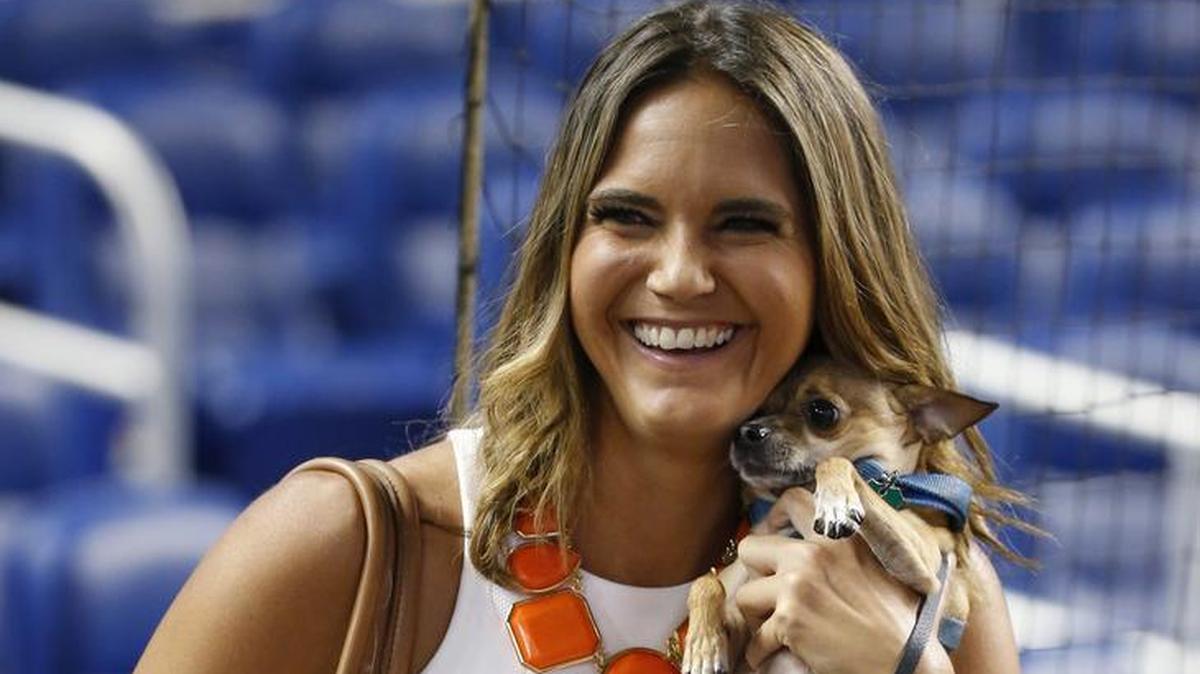 Fox Sports Florida in-game reporter Jessica Blaylock holds her dogs before the start of a baseball game between the Miami Marlins and the Arizona Diamondbacks during a “Bark at the Park,” event, Saturday, June 3, 2017, in Miami.
