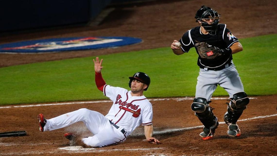 Atlanta Braves' Ender Inciarte, left, is forced out at home plate by Miami Marlins catcher J.T. Realmuto (11) while trying to score on Tyler Flowers' ground ball in the eighth inning of a baseball game Fri., May 27, 2016, in Atlanta. Atlanta won 4-2.