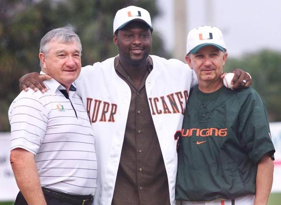 Florida Marlins catcher and UM alum Charles Johnson poses with former Miami baseball coach Ron Fraser, left, and current coach Jim Morris during Johnson’s jersey retirement ceremony in 2002.