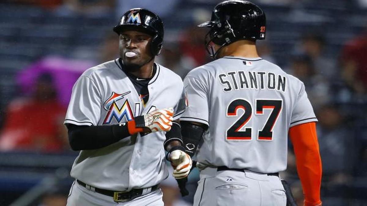 
Miami Marlins’ Adeiny Hechavarria, left, celebrates with Giancarlo Stanton (27) after scoring off of a ground out of Christian Yelich in the third inning of a baseball game against the Atlanta Braves, Monday, April 13, 2015, in Atlanta.
