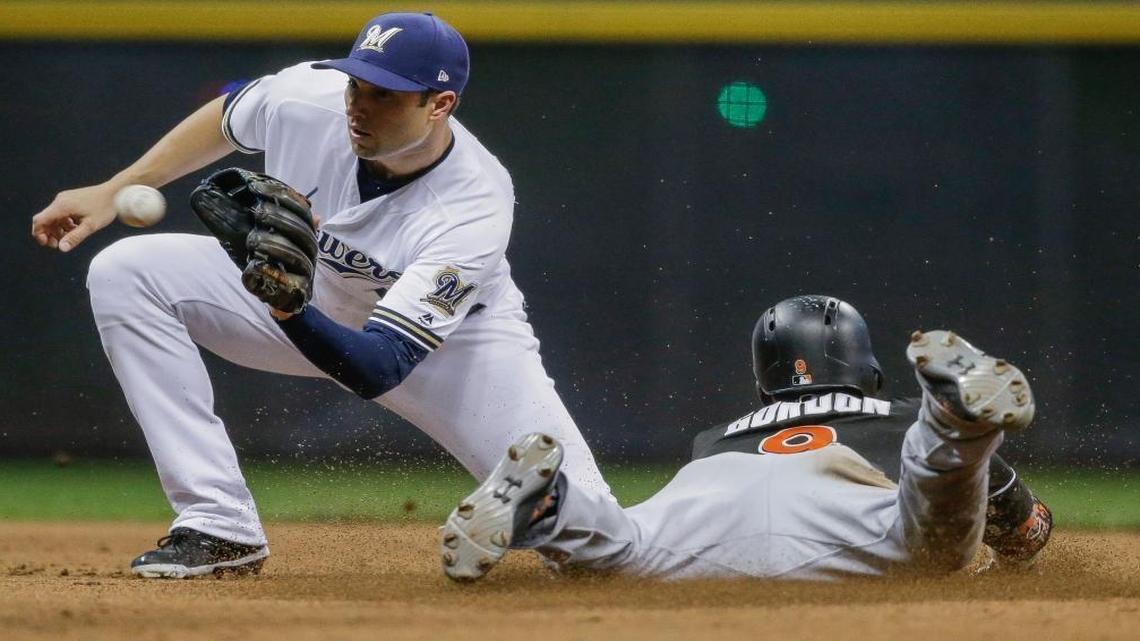 Miami Marlins’ Dee Gordon steals second as Milwaukee Brewers’ Neil Walker takes the throw during the seventh inning of a baseball game, Saturday, Sept. 16, 2017, in Milwaukee.