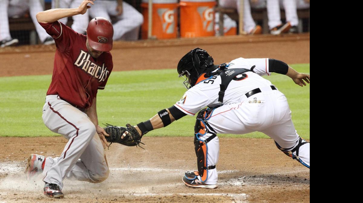 
The Arizona Diamondbacks’ A.J. Pollock steals home as Miami Marlins catcher Jhonatan Solano is late with the tag in the fifth inning at Marlins Park on Wednesday, May 20, 2015.
