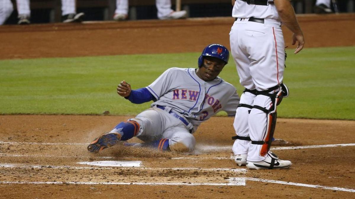 New York Mets center fielder Curtis Granderson slides safely into home during the third inning of a baseball game against the Miami Marlins at Marlins Park on Thurs., June 29, 2017 in Miami.