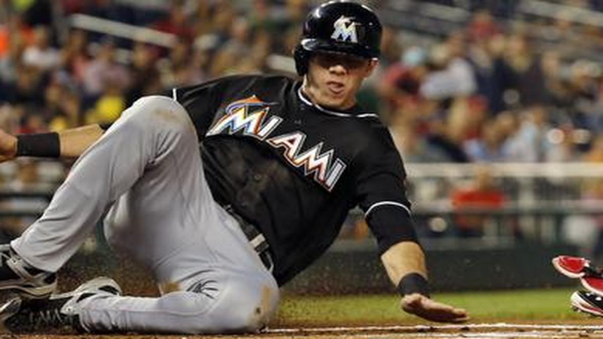 
Miami Marlins' Christian Yelich (21) slides safely into home as Washington Nationals catcher Wilson Ramos (40) waits for the throw, during the first inning of the second baseball game of a doubleheader at Nationals Park, Friday, Sept. 26, 2014, in Washington.

