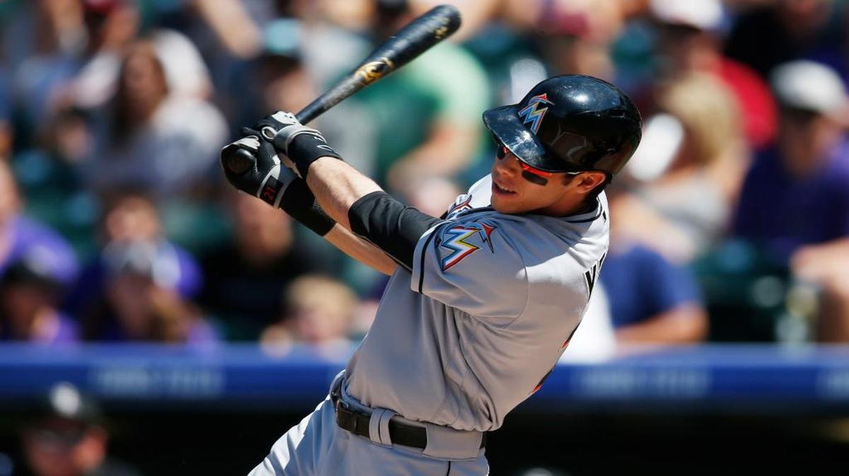 Miami Marlins' Christian Yelich follows the flight of his double to drive in two runs off Colorado Rockies starting pitcher Jon Gray in the first inning of a baseball game Sunday, Aug. 7, 2016, in Denver.