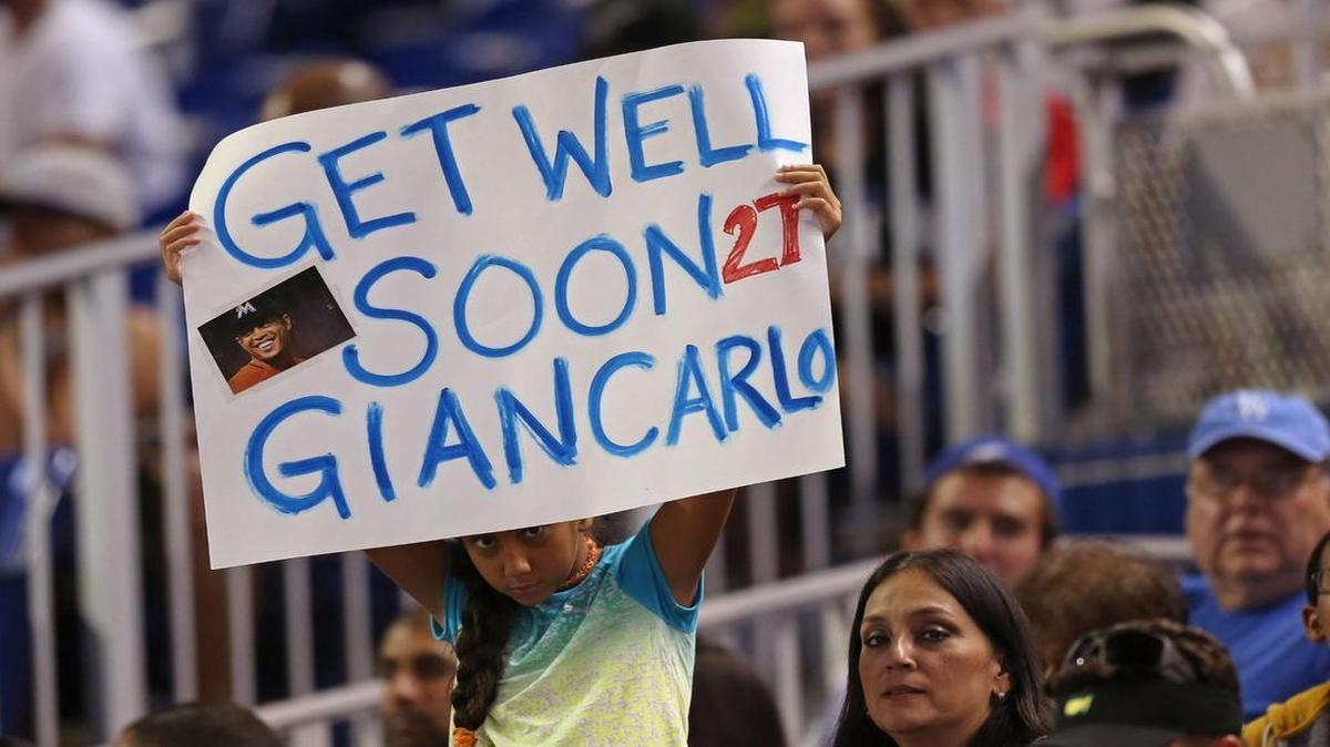 
A fan holds a get well sign for injured Giancarlo Stanton in between innings of the game between the Miami Marlins and the Los Angeles Dodgers at Marlins Park on June 27, 2015 in Miami, Florida.
