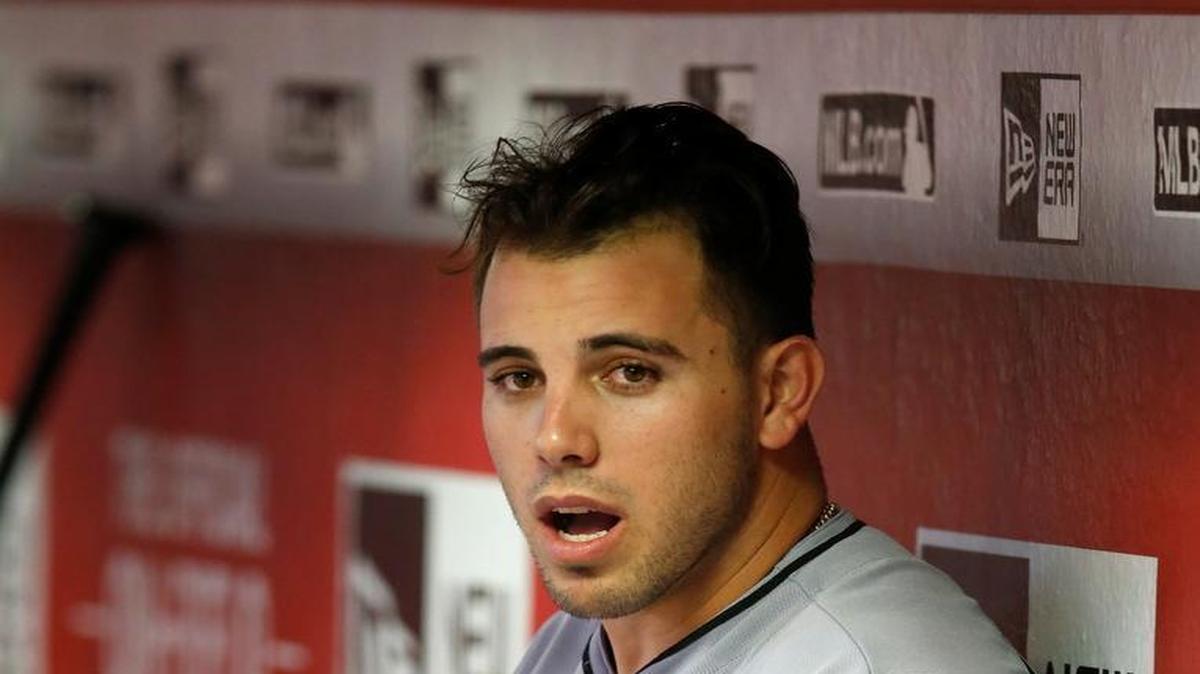 Miami Marlins pitcher Jose Fernandez sits in the dugout in the fifth inning during a baseball game against the Arizona Diamondbacks, Saturday, June 11, 2016, in Phoenix.