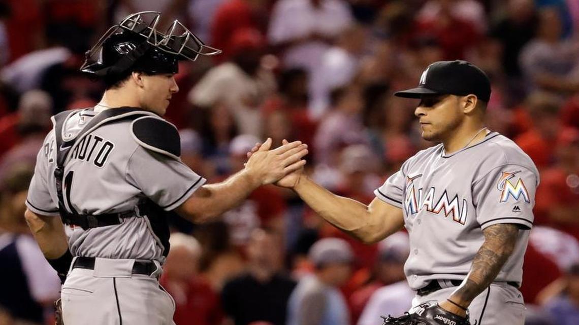 Miami Marlins relief pitcher A.J. Ramos, right, and catcher J.T. Realmuto celebrate following a 7-6 victory over the St. Louis Cardinals in a baseball game Fri., July 15, 2016, in St. Louis.