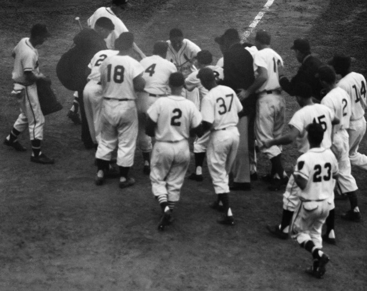 Stan Musial, on July 12, 1955 in Milwaukee, who couldn't get the ball out of infield in three previous attempts, crosses home plate after clouting first pitch of 12th inning over right field screen for game-winning homer to give National League All-Star 6-5 victory.