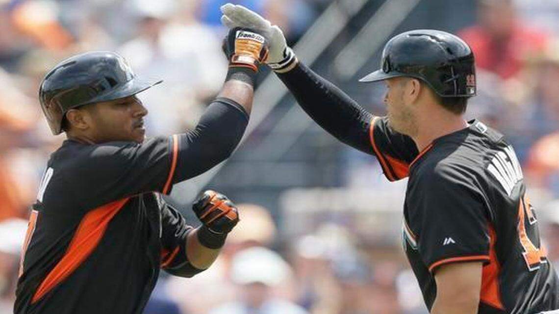 
Donovan Solano, left, is congratulated after his solo home run by Reid Brignac during the second inning of the Miami Marlins’ spring training baseball game against the Detroit Tigers in Lakeland, Fla., Wednesday, March 25, 2015.
