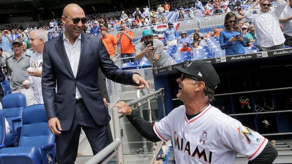 Miami Marlins CEO Derek Jeter, left, talks with manager Don Mattingly during the Marlins' MLB home season opener game against the Chicago Cubs on Thursday, March 29, 2018.