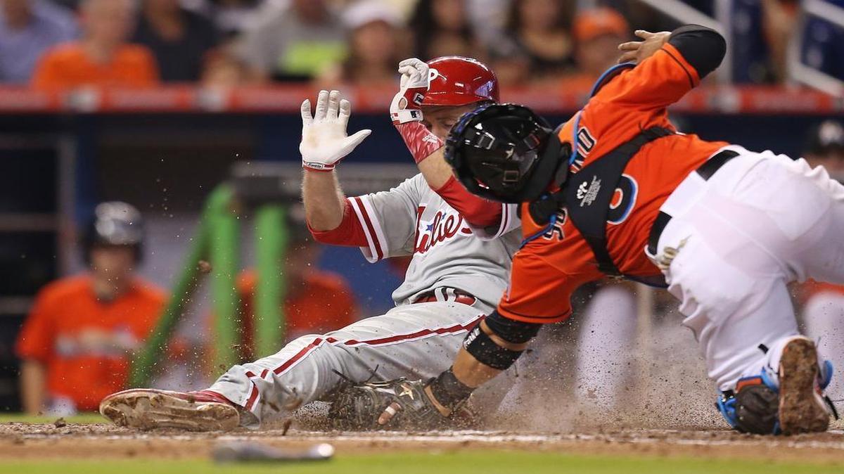 
The Phillies’ Chase Utley beats the tag by catcher Jhonatan Solano to score on Ryan Howard’s single in the seventh inning, giving Philadelphia a 5-2 lead in its 6-2 victory over the Marlins.
