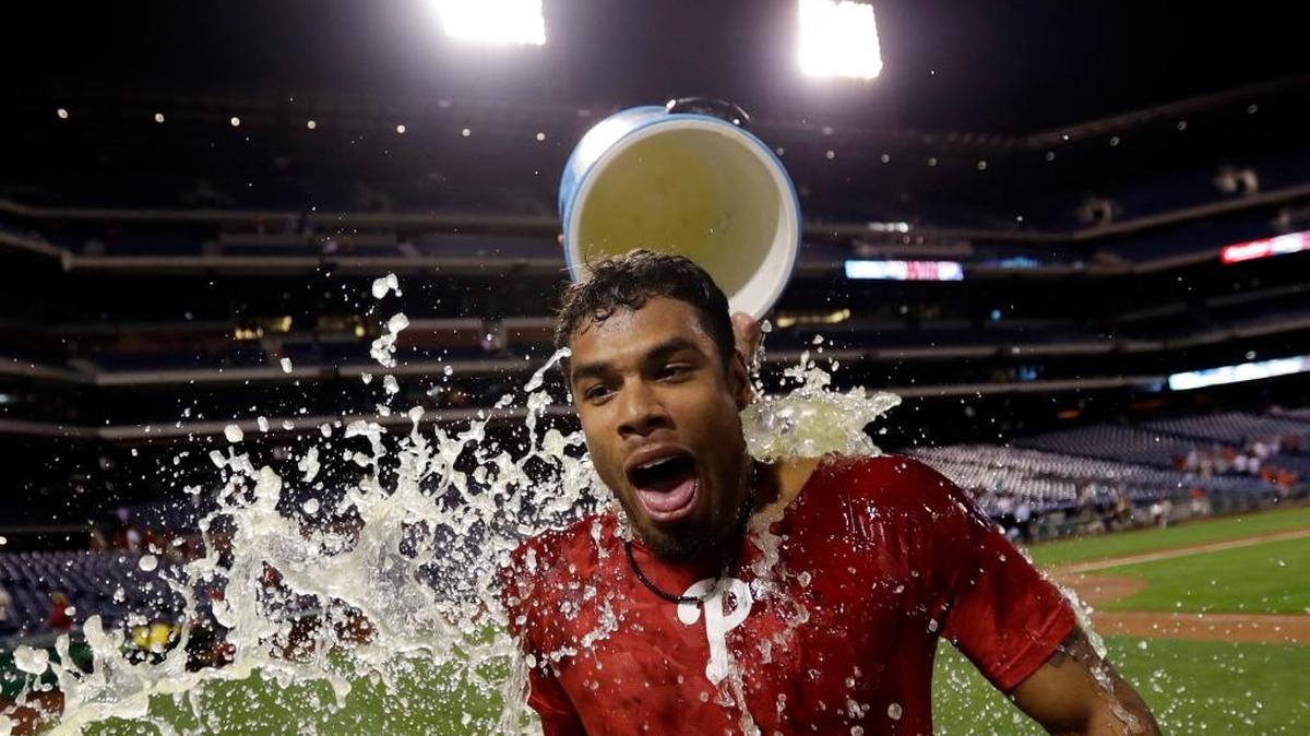Philadelphia Phillies' Nick Williams is doused by Cameron Rupp after Williams drove in the winning run with a double during the 15th inning against the Miami Marlins, early Wednesday, Sept. 13, 2017, in Philadelphia. Philadelphia won 9-8.