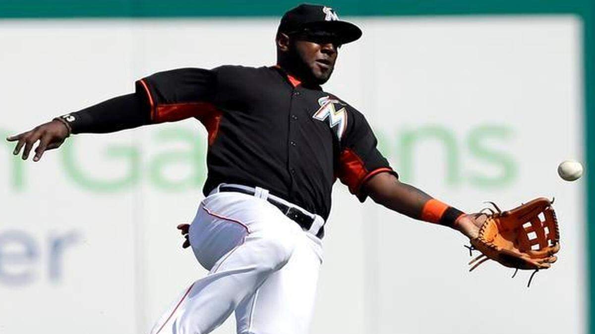
Miami Marlins center fielder Marcell Ozuna dives and catches a ball hit by the St. Louis Cardinals’ Thomas Pham during the fifth inning of a spring training game Thursday, March 5, 2015, in Jupiter, Fla. 
