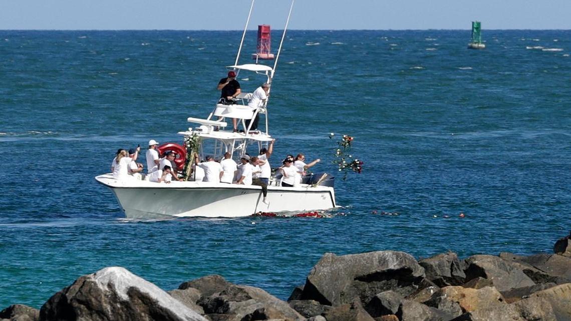Mourners aboard a boat toss flowers into the ocean Fri., Sept. 30, 2016, off of Miami Beach, Fla., near the spot along a jetty where Miami Marlins pitcher Jose Fernandez and two friends were killed last weekend, A private Catholic mass attended by about 300 friends and relatives was held Thursday.