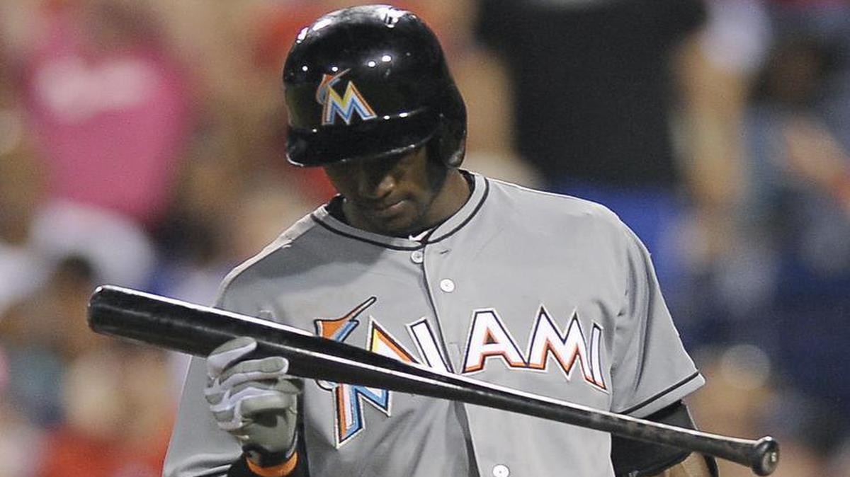 
Miami Marlins' Adeiny Hechavarria throws his bat after striking out in the eighth inning of a baseball game against the Philadelphia Phillies, Saturday, July 18, 2015, in Philadelphia. The Phillies won 3-1. 
