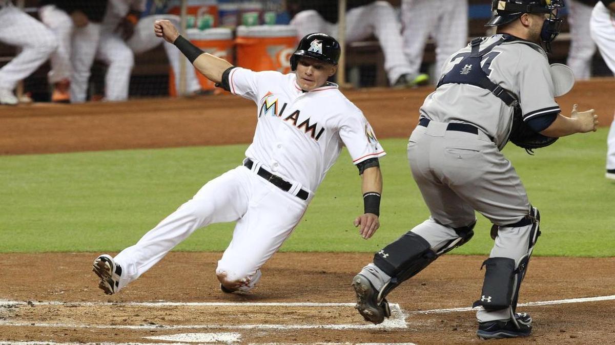
Derek Dietrich, third baseman of the Miami Marlins, scores in the second inning of a baseball game against the New York Yankees on Monday, June 15, 2015 at Marlins Park in Miami.
