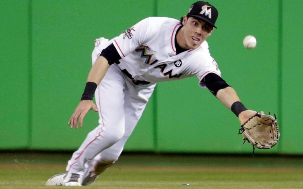 Miami Marlins center fielder Christian Yelich goes for a ball hit by Washington Nationals' Anthony Rendon for the out during the fifth inning of a baseball game, Wed., Aug. 2, 2017, in Miami.