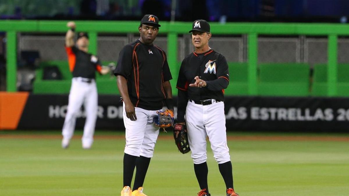 Miami Marlins manager Don Mattingly talks with center fielder Marcell Ozuna before the start of a game in June at Marlins Park.