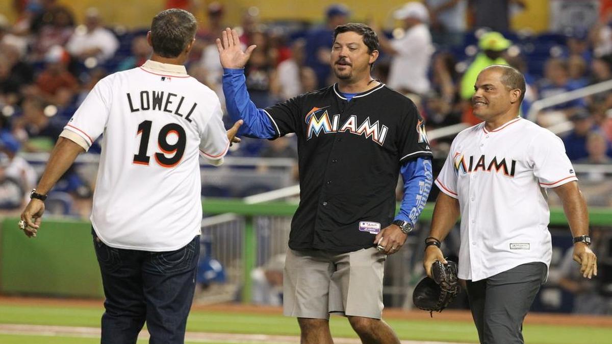 
Former Marlins pitcher Josh Beckett, center, throws out the first pitch before the Miami Marlins’ game against the Los Angeles Dodgers at Marlins Park in Miami on Sunday, June 28, 2015. He was joined by Mike Lowell, left, and Ivan ‘Pudge’ Rodriguez, right.
