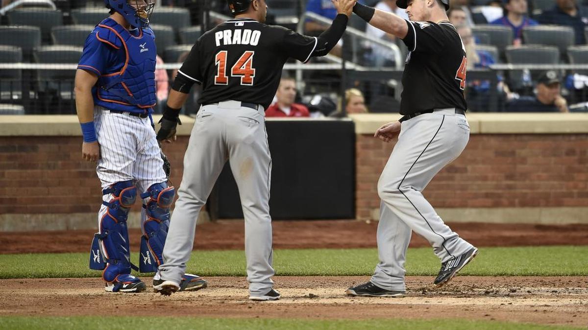 
power play: Martin Prado greets Justin Bour at home plate after scoring on Bour’s three-run homer that gave the Marlins a 3-0 lead in the fourth inning.

