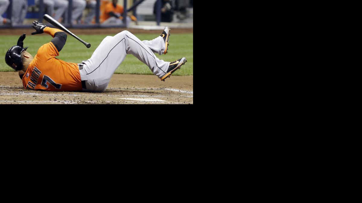 
In this photo taken on Thursday, Sept. 11, 2014, Miami Marlins' Giancarlo Stanton falls after he was hit by a pitch during the fifth inning of a baseball game against the Milwaukee Brewers in Milwaukee. Stanton sustained multiple facial fractures, dental damage and cuts that needed stitches after being hit in the face by a fastball from Milwaukee's starting pitcher Mike Fiers. 
