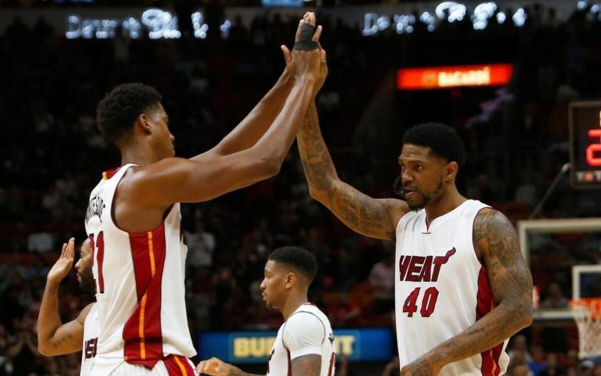 Miami Heat center Hassan Whiteside high fives teammate Udonis Haslem after he entered the game during the fourth quarter Wednesday, April 12, 2017.