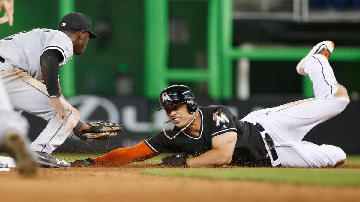 Chicago White Sox shortstop Tim Anderson, left, tags out Miami Marlins' Giancarlo Stanton as he attempts to reach second base during the ninth inning of a baseball game, Saturday, Aug. 13, 2016, in Miami. Stanton singled with two out in the ninth but was an easy out trying to stretch the hit into a double. The White Sox defeated the Marlins 8-7.