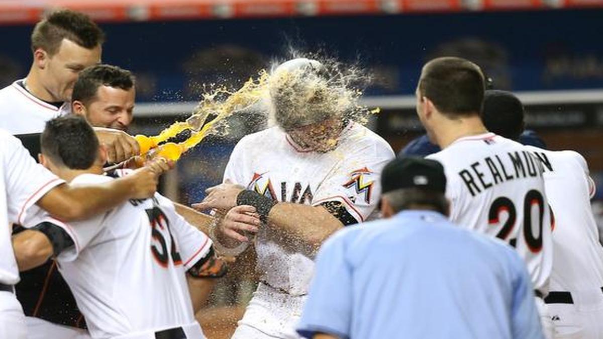 
Justin Bour gets doused by his teammates after belting a three-run home run in the bottom of the ninth to lift the Marlins to their second victory in a row over the Giants.
