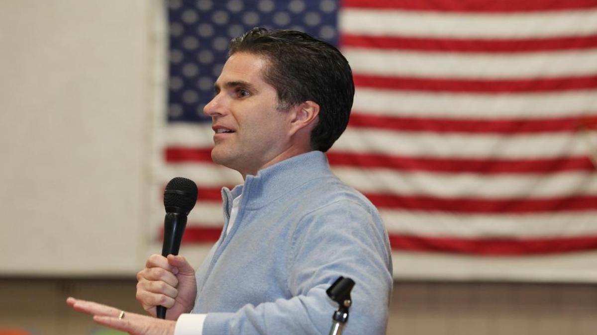 Tagg Romney speaks on behalf of his father, Republican presidential candidate Mitt Romney, during the Kennebec County Super Caucus in Augusta, Maine on Saturday, Feb. 4, 2012.