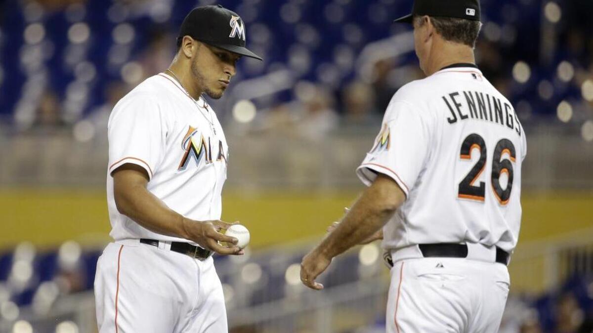 
Miami Marlins relief pitcher A.J. Ramos hands the ball to manager Dan Jennings after being relieved in the 11th inning against the San Diego Padres, Friday, July 31, 2015, in Miami. 
