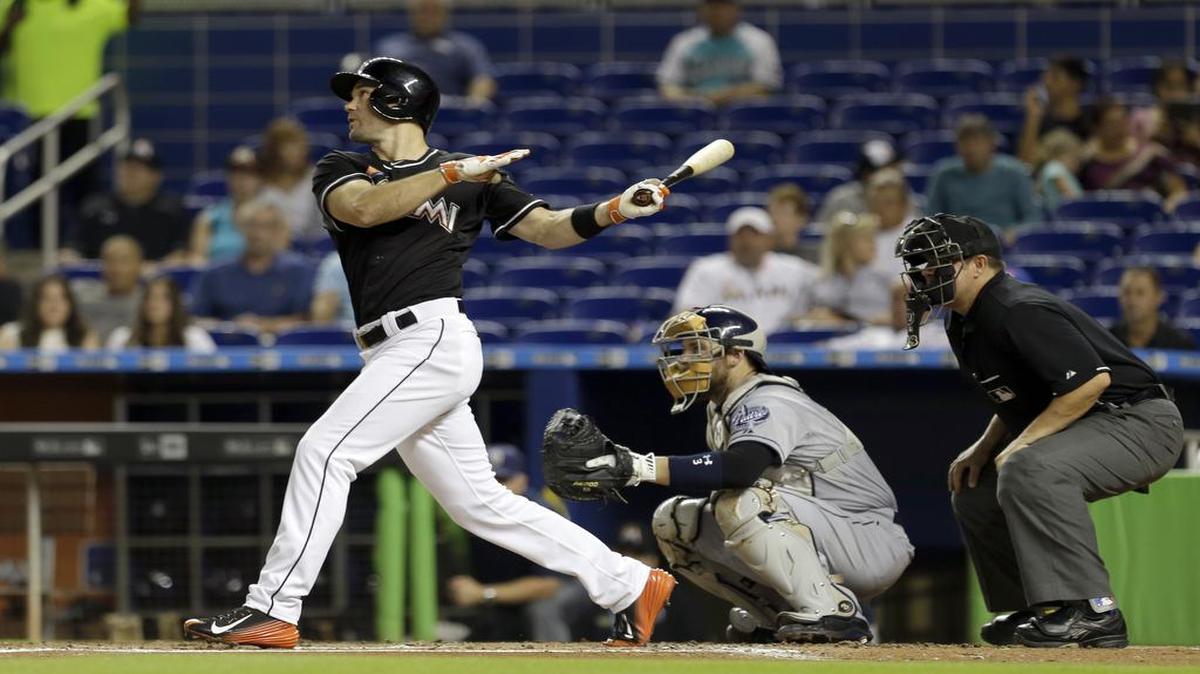 
Miami Marlins' Cole Gillespie (28) follows through on a base hit against the San Diego Padres in the first inning of a baseball game, Saturday, Aug. 1, 2015, in Miami.
