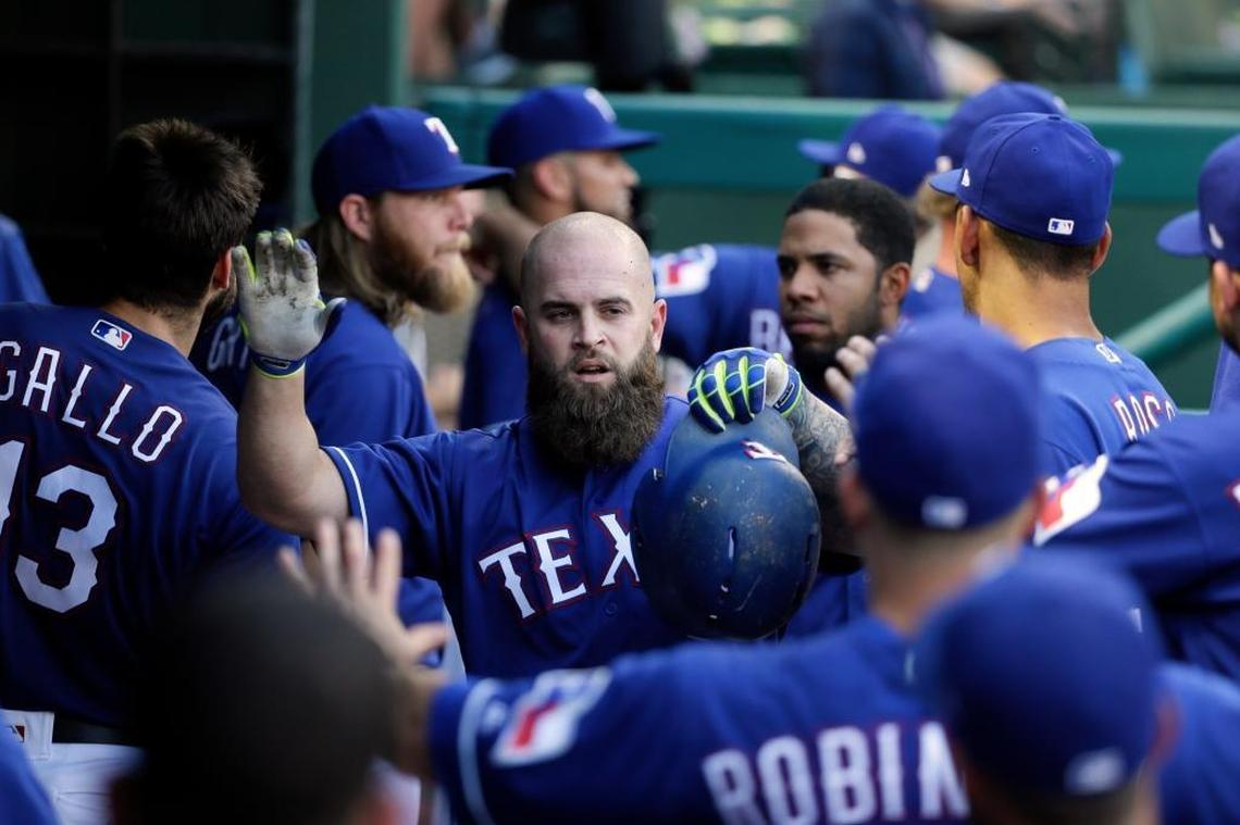 Texas Rangers' Mike Napoli is congratulated in the dugout after hitting a solo home run during the second inning of the team's baseball game against the Miami Marlins on Tues., July 25, 2017, in Arlington, Texas.