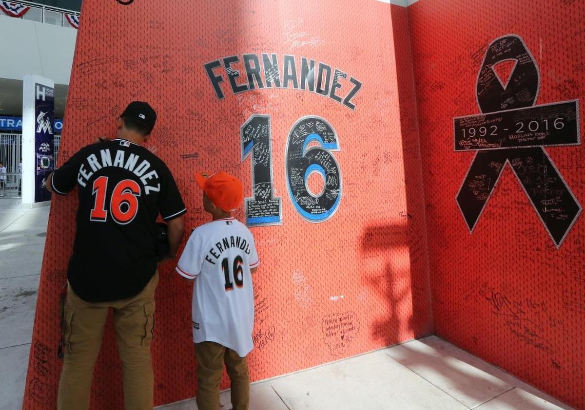 Dominic Estevez, left, and his brother Armani Estevez look at the Jose Fernandez tribute before the Miami Marlins' home opener against the Atlanta Braves at Marlins Park on April 11, 2017.