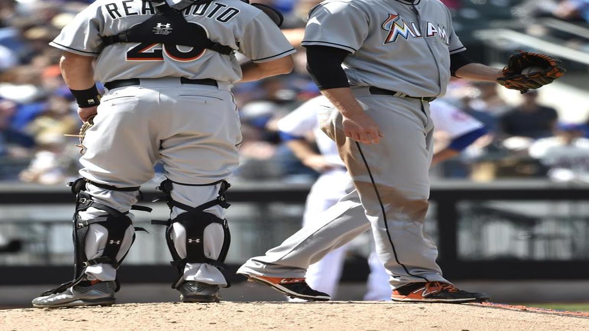 
Miami Marlins catcher Jacob Realmuto (20) talks with starting pitcher Tom Koehler on the mound after he gave up two runs to the New York Mets in the fourth inning of a baseball game at Citi Field on Sunday, April 19, 2015, in New York. The Mets won 7-6. 
