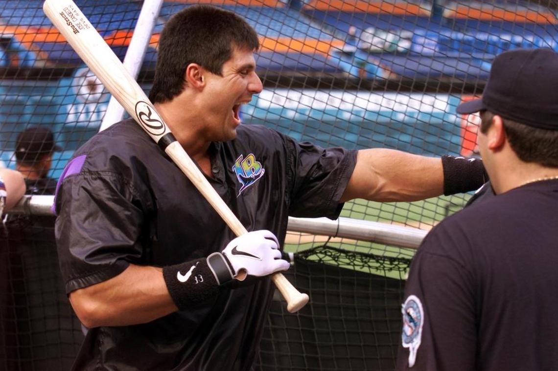 Tampa Bay’s Jose Canseco (Coral Park High) talks to Florida pitcher Alex Fernandez (Monsignor Pace) in 1997.