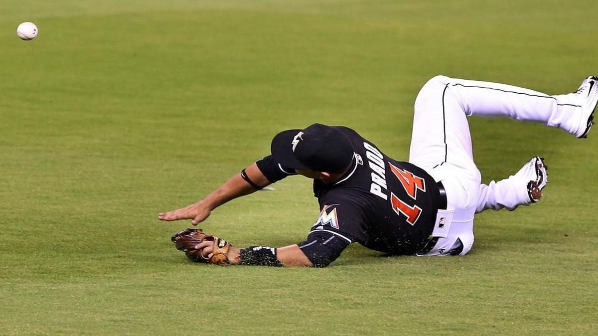 Martin Prado, third baseman of the Miami Marlins cannot reach a ball hit by the Atlanta Braves' Nick Markakis, allowing two runs in the second inning of the Marlins against Atlanta Braves game at Marlins Park in on Saturday, April 16, 2016.