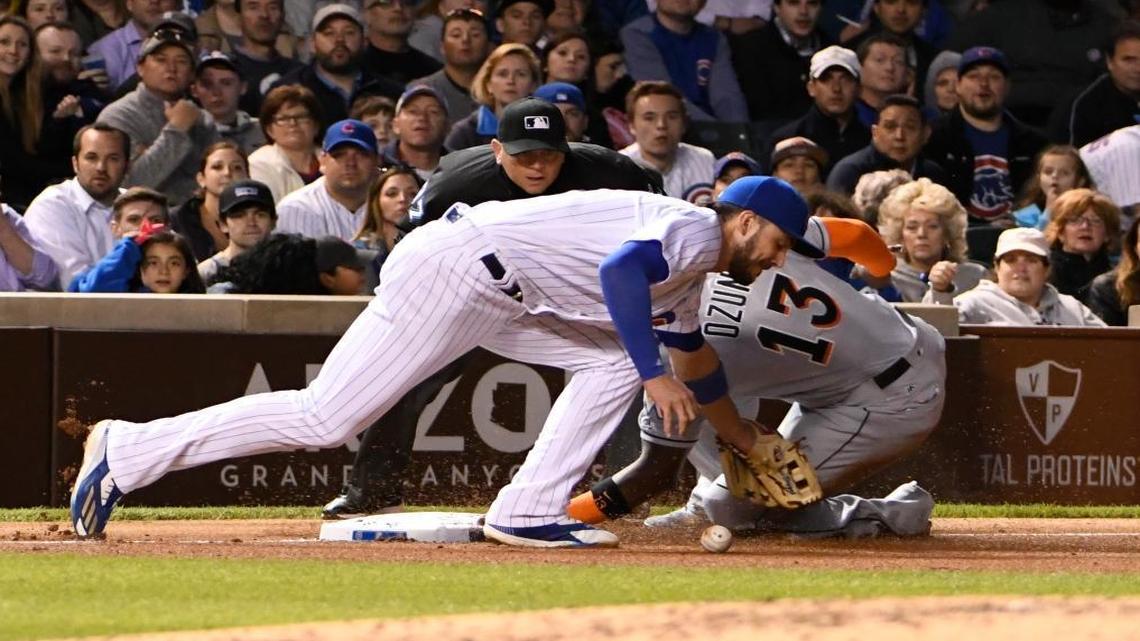 Miami Marlins' Marcell Ozuna (13) slides safely into third base as Chicago Cubs third baseman Kris Bryant, left, takes a late throw during the seventh inning of a baseball game, Mon., June 5, 2017, in Chicago.