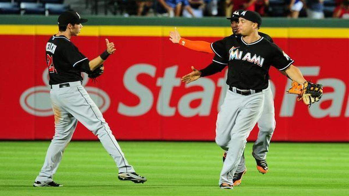 
Christian Yelich, left, Giancarlo Stanton and Marcell Ozuna (obscured) will provide the Marlins outfield stability until at least 2018. 
