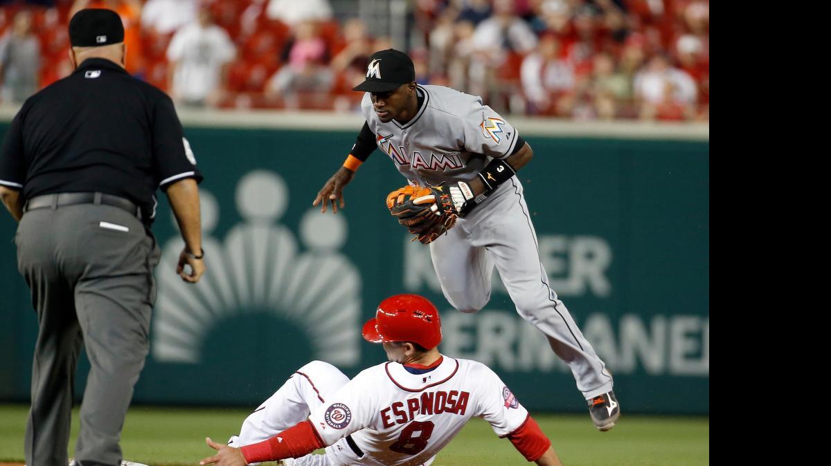 
Washington Nationals' Danny Espinosa (8) is safe at second base as Miami Marlins shortstop Adeiny Hechavarria (3) can't handle the throw during the ninth inning at Nationals Park, Tuesday, May 5, 2015, in Washington. The Marlins won 2-1.
