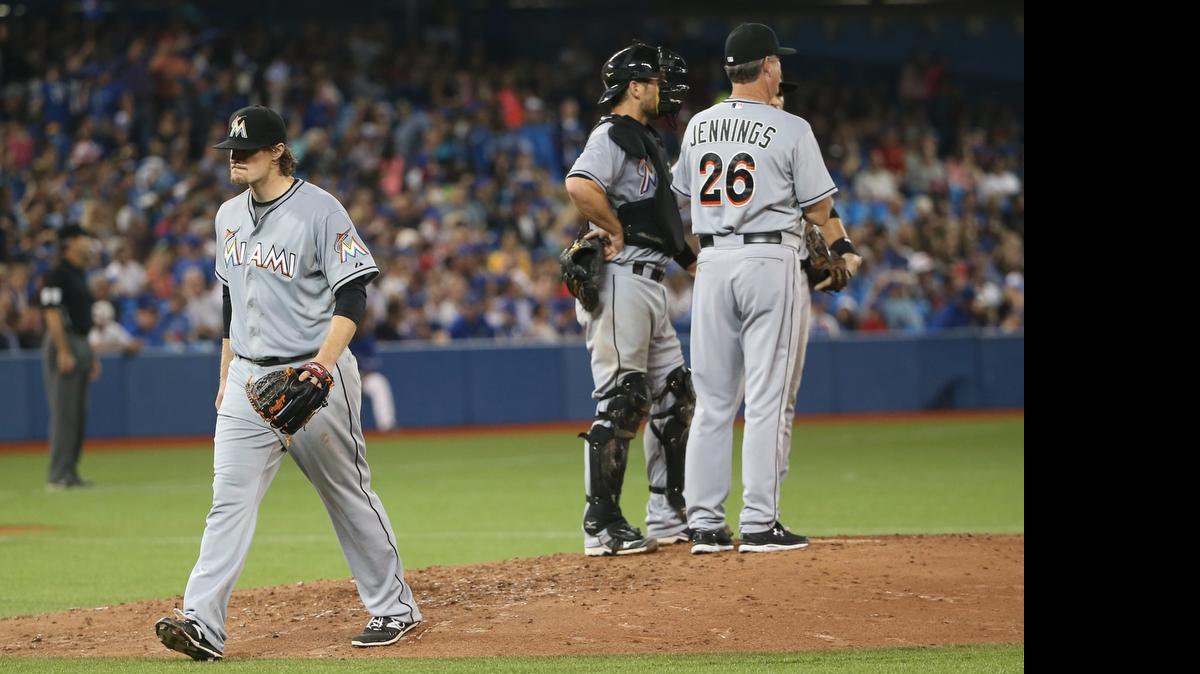 
Tom Koehler #34 of the Miami Marlins exits the game after being relieved by manager Dan Jennings #26 in the seventh inning against the Toronto Blue Jays on June 10, 2015 at Rogers Centre in Toronto. 
