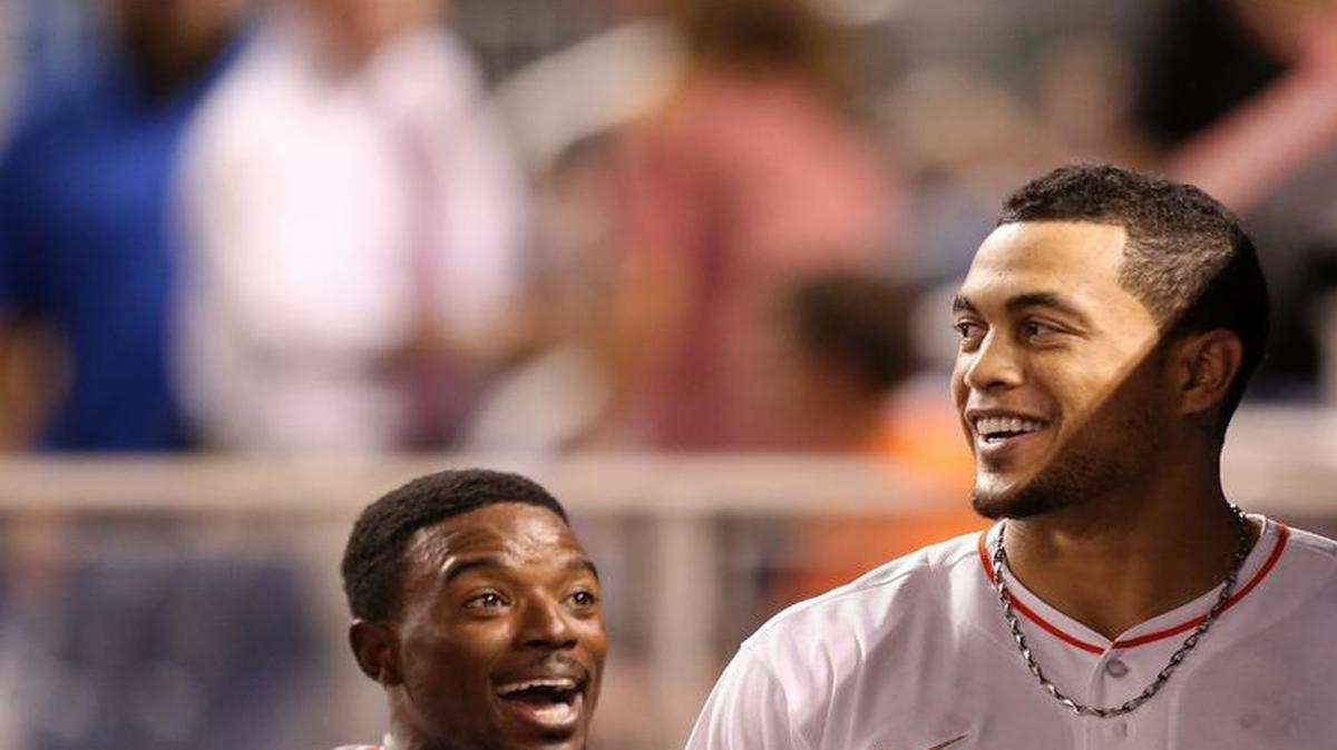 
Dee Gordon #9 and Giancarlo Stanton #27 of the Miami Marlins react in the dugout after scoring off a Stanton two run home run during the sixth inning of the game against the Arizona Diamondbacks at Marlins Park on May 19, 2015 in Miami, Florida. 
