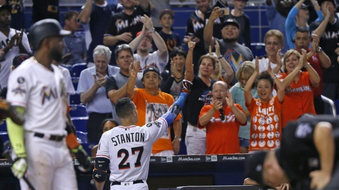 Giancarlo Stanton, center, gets a standing ovation from some fans after striking out at the bottom of the 9th inning. The Miami Marlins played its last game of the season against the Atlanta Braves as Giancarlo Stanton attempted to tie Babe Ruth's season home run record on Sunday, October 1, 2017.