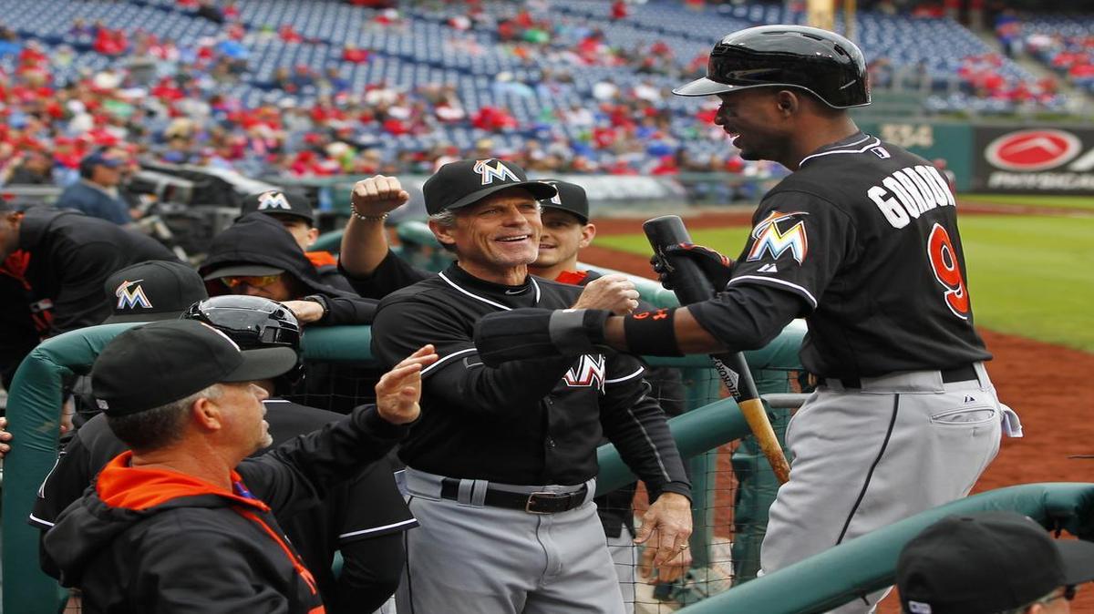 
Miami Marlins' Dee Gordon (9) is congratulated in the dugout by teammates after scoring on a double by Justin Bour in the first inning against the Philadelphia Phillies during a baseball game Sunday, Oct. 4, 2015, in Philadelphia.
