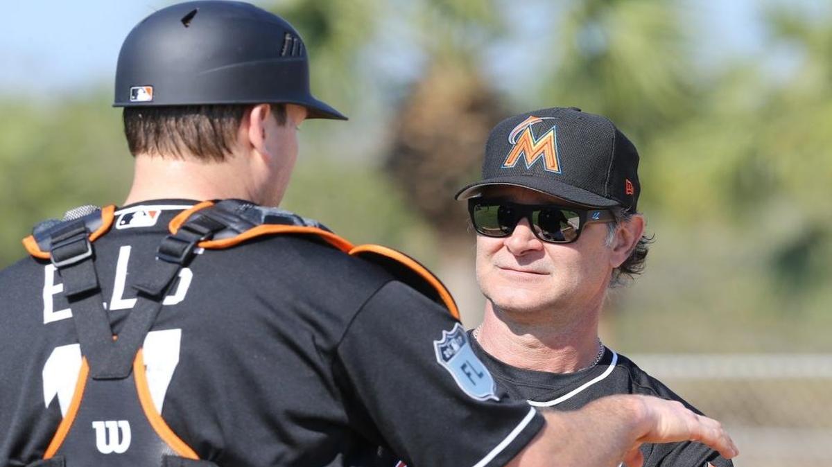 Miami Marlins manager Don Mattingly talks with catcher A.J. Ellis during training at the Marlins facility in Jupiter, Florida, Feb. 15, 2107.