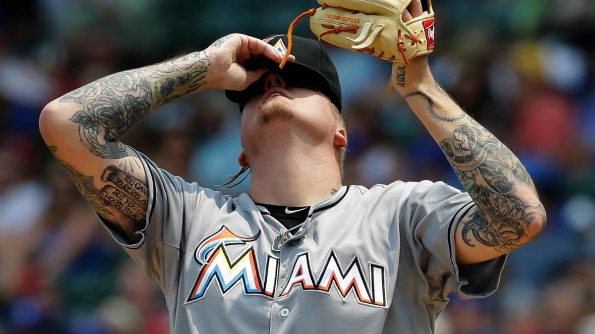 
Miami Marlins starter Mat Latos reacts after Chicago Cubs' Kris Bryant hit a single during the first inning of a baseball game Sunday, July 5, 2015, in Chicago. 
