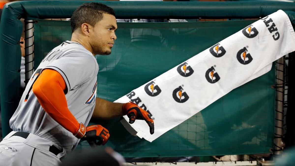 
Miami Marlins right fielder Giancarlo Stanton (27) pauses in the dugout during the a baseball game against the Washington Nationals at Nationals Park, Tuesday, May 5, 2015, in Washington. 
